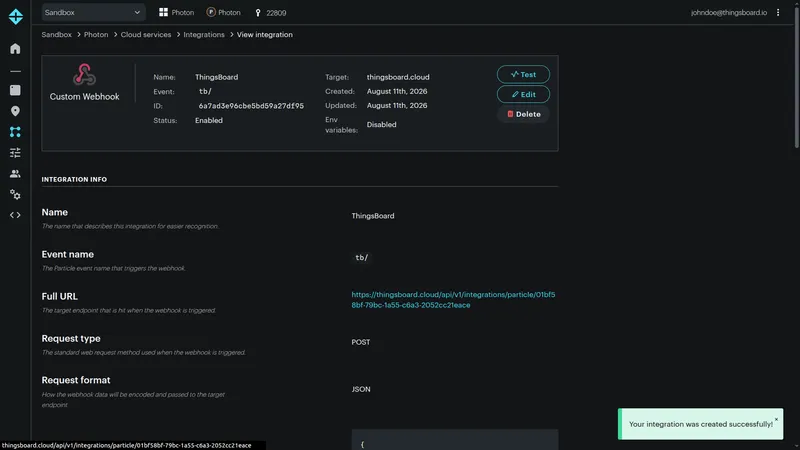 Particle Console — View integration page showing Custom Webhook Name ThingsBoard, Event tb/, Status Enabled, Target thingsboard.cloud, with Test, Edit, and Delete actions, and a success toast Your integration was created successfully