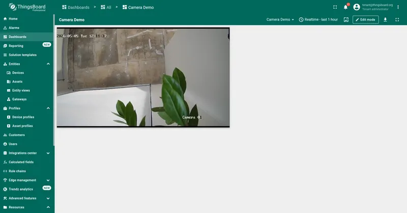 Camera Demo dashboard in view mode with the HLS Video Stream widget playing a live feed of an outdoor scene labeled Camera 01, with the in-frame camera timestamp visible.